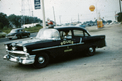 picture of Highland Police chief 1955 in his Squad car